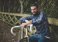 Hipster man with a fixie bike and smiling Royalty Free Stock Photo