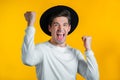 Hipster man in hat is very glad and happy, he shows yes gesture of victory, guy achieved result, goals. Surprised Royalty Free Stock Photo