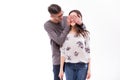 Hipster man keeps his girlfriend eyes covered, romantic surprise.