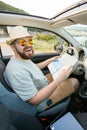 Hipster man looking on location navigation map in car, tourist traveler driving and hold in male hands europe Royalty Free Stock Photo