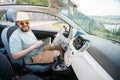 Hipster man looking on location navigation map in car, tourist traveler driving and hold in male hands europe Royalty Free Stock Photo