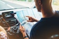 Hipster man looking and point finger on location navigation map in car, tourist traveler driving and hold in male hands europe car Royalty Free Stock Photo