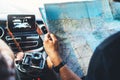 Hipster man looking and point finger on location navigation map in car, tourist traveler driving and hold in male hands europe car Royalty Free Stock Photo