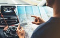 Hipster man looking and point finger on location navigation map in car, tourist traveler driving and hold in male hands europe car Royalty Free Stock Photo