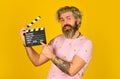 Hipster man with movie clapper. Man holding film clapper. Professional male actor ready for shooting film. prepares for Royalty Free Stock Photo