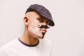 Hipster man with paper mustache making fanny face Royalty Free Stock Photo