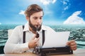 Hipster man with a pipe reflecting on his typewriter in front of sea background Royalty Free Stock Photo