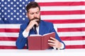 Hipster man reading book USA flag background, study hard concept Royalty Free Stock Photo