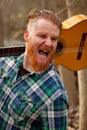 Hipster man with red beard shouting while hold a guitar Royalty Free Stock Photo
