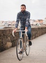 Hipster man riding in a fixie bike Royalty Free Stock Photo