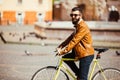 Hipster man riding in a fixie bike in the sunny city streets. Royalty Free Stock Photo