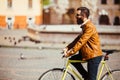 Hipster man riding in a fixie bike in the sunny city streets. Royalty Free Stock Photo