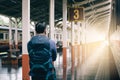 Hipster man standing at platform train station waiting and looking future concept