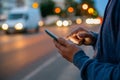 Hipster man talking on a mobile phone at night in the city against the background of bokeh lights Royalty Free Stock Photo