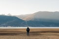 Hipster man traveler with sweater and backpack traveling at Napa Lake, Happy young Hiker looking mountain and sunset in trip Royalty Free Stock Photo