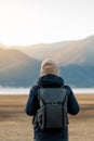 Hipster man traveler with sweater and backpack traveling at Napa Lake, Happy young Hiker looking mountain and sunset in trip Royalty Free Stock Photo