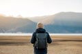 Hipster man traveler with sweater and backpack traveling at Napa Lake, Happy young Hiker looking mountain and sunset in trip Royalty Free Stock Photo