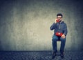 Hipster man using an old red telephone Royalty Free Stock Photo