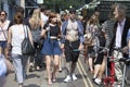 Hipster man and woman dressed in cool Londoner style walking in Brick lane, a street popular among young trendy people Royalty Free Stock Photo