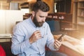 Hipster man working, checking email, blogging, reading, learning. Instagram filter.