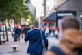 Hipster manager with smart phone walking in the street