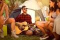 Hipster man camping with friends Royalty Free Stock Photo