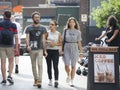 Hipster men and woman dressed in cool Londoner style walking in Brick lane, a street popular among young trendy people Royalty Free Stock Photo
