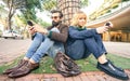 Hipster millennial couple in disinterest moment with smartphone - Apathy concept about sadness and isolation using mobile phone