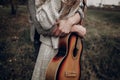 Hipster musician couple hugging in field, handsome man embracing