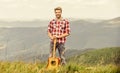 Hipster musician. Inspiring environment. Summer music festival outdoors. Playing music. Man musician with guitar on top