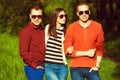 Hipster people concept. Portrait of fashionable friends in trendy casual clothing walking in the park together. Stylish eyewear. Royalty Free Stock Photo