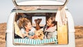 Hipster people with cute dog traveling together on vintage minivan - Wanderlust and life inspiration concept with hippie couple