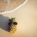 Hipster pineapple on beach - fashion in summer. Royalty Free Stock Photo