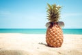 Hipster pineapple with sunglasses on a sandy at tropical beach.