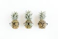 Hipster pineapples in glasses on white background. Flat lay, top view