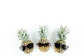 Hipster pineapples in glasses on white background. Flat lay, top view