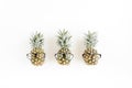 Hipster pineapples in glasses on white background. Flat lay, top view