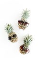 Hipster pineapples in glasses on white background. Flat lay, top view