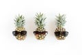 Hipster pineapples in glasses on white background. Flat lay, top view