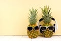 Hipster pineapples with sunglasses and headphones against yellow Royalty Free Stock Photo