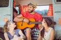 Hipster playing guitar for girls