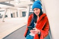 Hipster portrait of happy young woman with smartphone