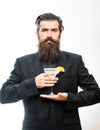 Hipster prepared cocktail. Man holds glass, delicious cocktail with orange.