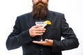 Hipster prepared cocktail. Man holds glass, delicious cocktail with orange,