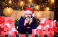 Hipster prepared gifts for family. Happy winter holidays. Warming up. Tea time. Man bearded santa claus hat drinking hot