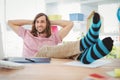 Hipster realaxing with legs on desk Royalty Free Stock Photo