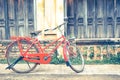 Hipster red bicycle in old building walls background Royalty Free Stock Photo