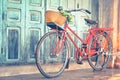 Hipster red bicycle in old building walls background Royalty Free Stock Photo