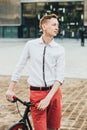 Hipster with red bycicle and tattoo on leg Royalty Free Stock Photo