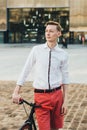 Hipster with red bycicle and tattoo on leg Royalty Free Stock Photo